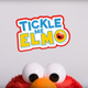 Elmo sure looks different once he takes off his sunglasses and hoodie.